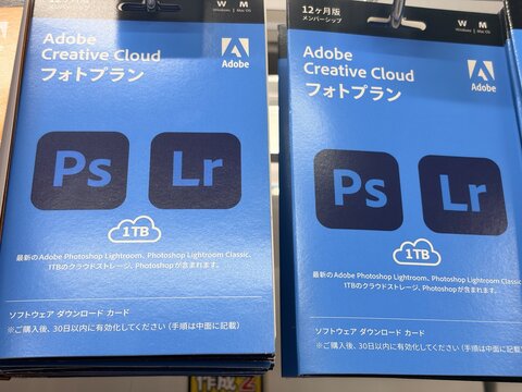 Adobe Creative Cloud Photography Plan prepaid software cards for Photoshop and Lightroom on retail display with 1TB cloud storage - Tokyo, Japan, December 22, 2025