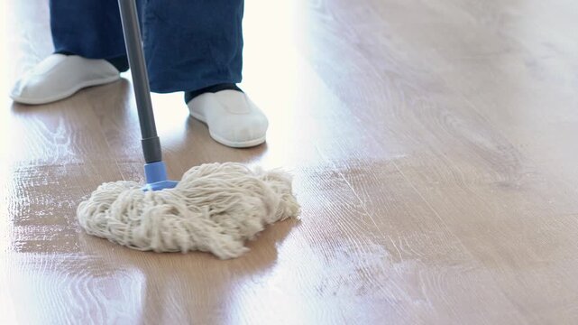Home, spring cleaning and person with mop, floor or bucket with chemical for disinfection or chores. Legs and prevention of germs in apartment, routine and removal of dirt with equipment at office