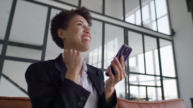 Business Woman Celebrating Success on Smartphone
