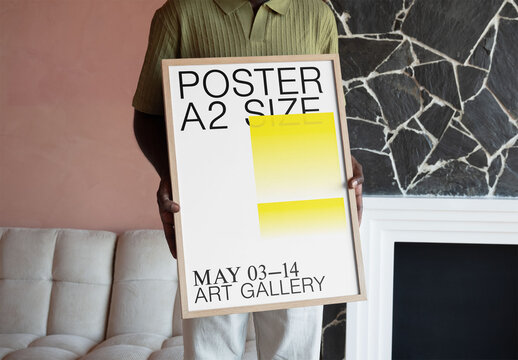 Mockup Of Man And Customized Framed A2 Poster
