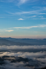 Naklejka premium Misty Mountains Under a Blue Sky