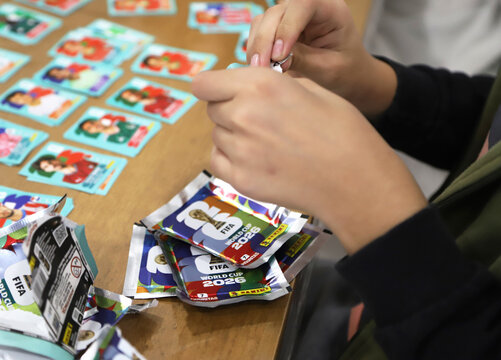 Person opening a pack of stickers for the 2026 FIFA World Cup. Panini sticker pack