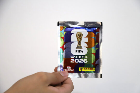 Person holding a pack of stickers from the 2026 FIFA World Cup. Panini sticker pack