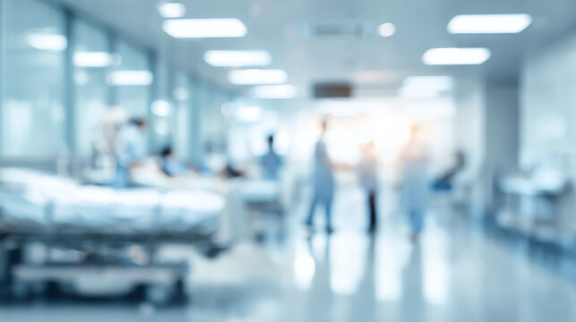 Blurred view of a busy hospital ward with medical staff attending to patients in a healthcare setting.