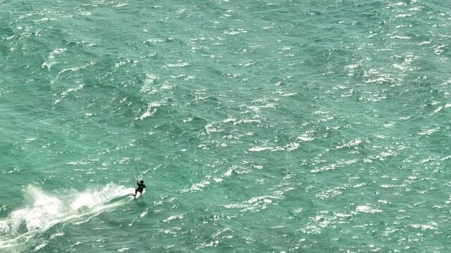 Action Packed Aerial View of Kitesurfer Riding Waves in Turquoise Mediterranean Sea Dynamic Water Sports and Extreme Adventure