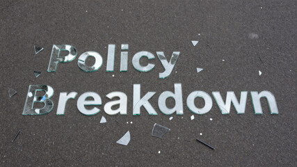 Fototapeta premium Fragmented metallic lettering on rough surface illustrating institutional collapse policy disintegration and fractured governance under social pressure