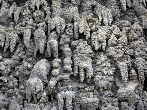 Close-Up of Artificial Stalactite Formations and Textured Rock Surface in Gray Wall