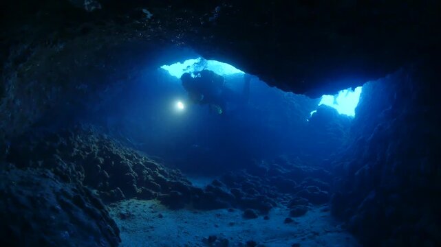 cave diving underwater scuba divers exploring caves and having fun ocean scenery sun beams and rays background