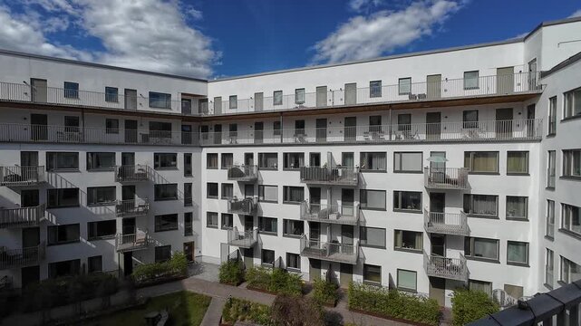 Modern White Apartment Buildings in Solna Stockholm Under Clear Blue Sky