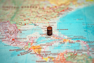 Fototapeta na wymiar Small oil barrel placed on Cuba map.