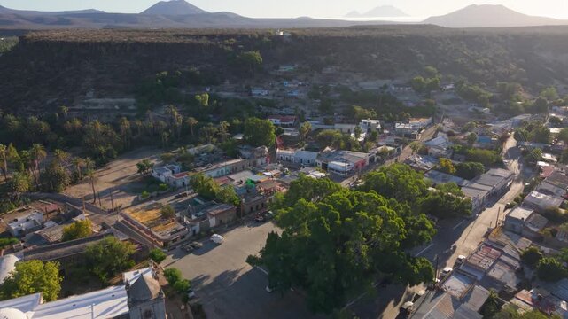 Discover aerial sights of Mission Church in San Ignacio, Baja California, Mexico capturing the town and oasis view during a sunny day