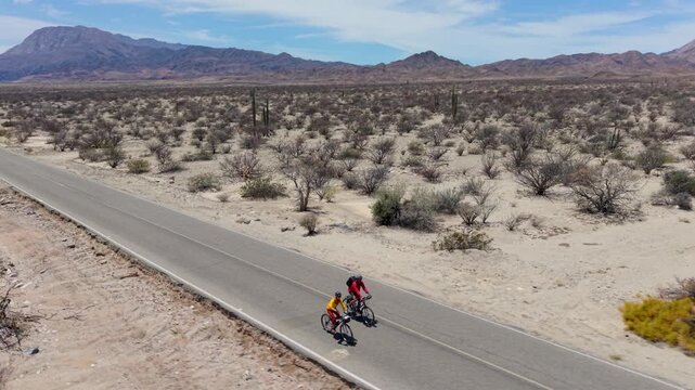 Two bikers enjoy the route near La Gringa along Bahia De Los Angeles by the Sea of Cortez in Baja California.