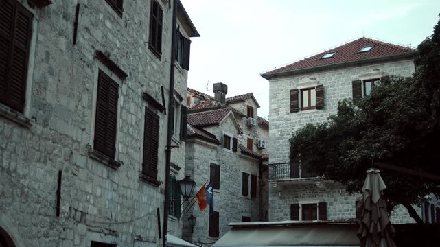 Cinematic ground-level footage of Kotor featuring narrow stone streets, medieval architecture, cozy atmosphere, and Adriatic coastal charm.