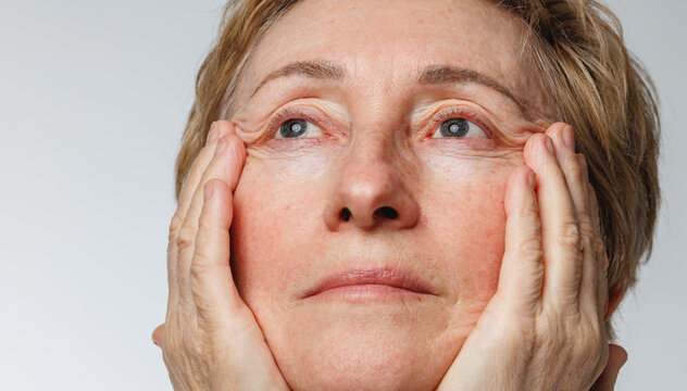 Close portrait of senior woman with natural skin texture and aging beauty concept.