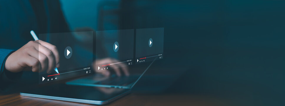 Businesswoman using tablet and laptop with digital video player interface for online streaming, media playback, video marketing, content creation and multimedia technology concept.