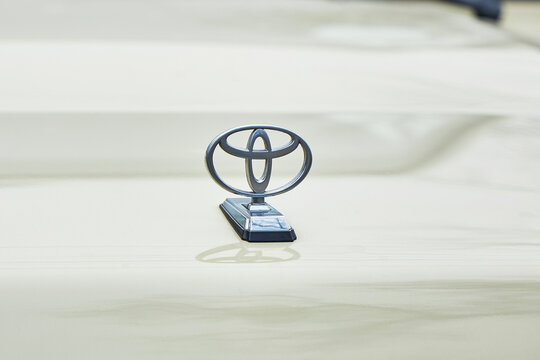 Toyota metallic chrome car emblem on hood. Vehicle, automotive logo. Classic motor car design element on bonnet for automobile industry and transportation concept. Bishkek, Kyrgyzstan - 21 MAR 2026.