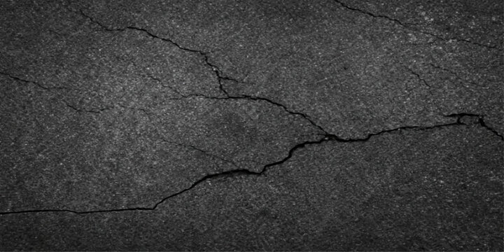 A grunge pattern of old cracked asphalt and rough grey concrete creates a broken, textured surface on this weathered stone road and dry cement wall background