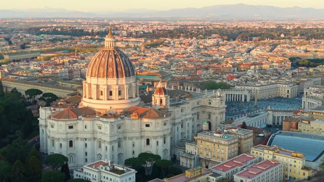 Aerial city view St. Peter's basilica in Rome, aerial shot at sunset with drone. San Pietro, Roma. 