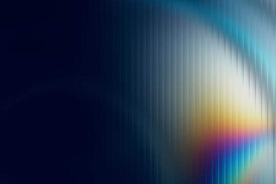 Iridescent prismatic light streak over dark blue textured background.