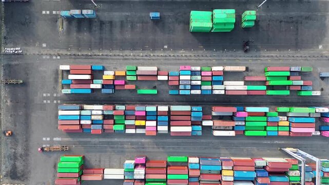 Colorful cargo containers arranged at industrial shipping terminal aerial