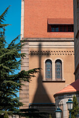 Fototapeta premium The spire of the cross casts a shadow on the exterior of the church building in Qingdao, China