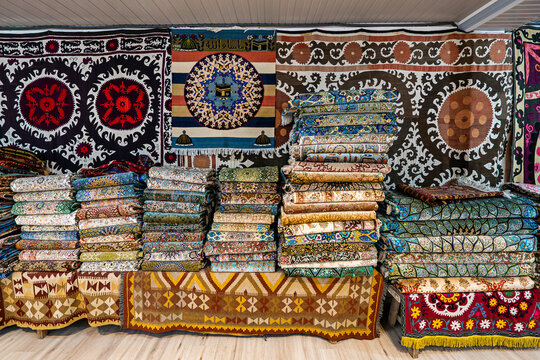 Traditional colorful berber hand woven wool carpets and rugs at middle eastern bazaar. Berber craftmanship with geometrical patterns at traditional souk