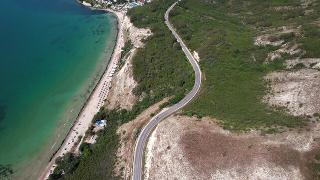 Aerial view of a winding road along the white cliffs and turquoise waters of the Black Sea coast near Kaliakra Dobrich Province, Bulgaria.