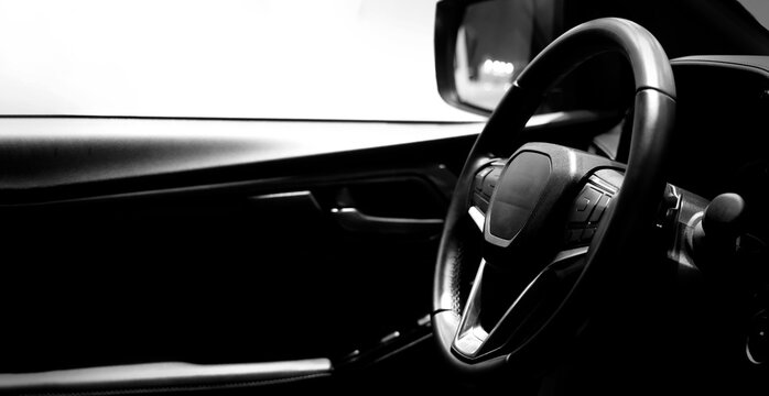 EV Car steering wheel. Modern car interior with luxury steering wheel dashboard and digital monitor controls. Steering wheel and automotive cabin. Car technology comfort and premium design in EV car.
