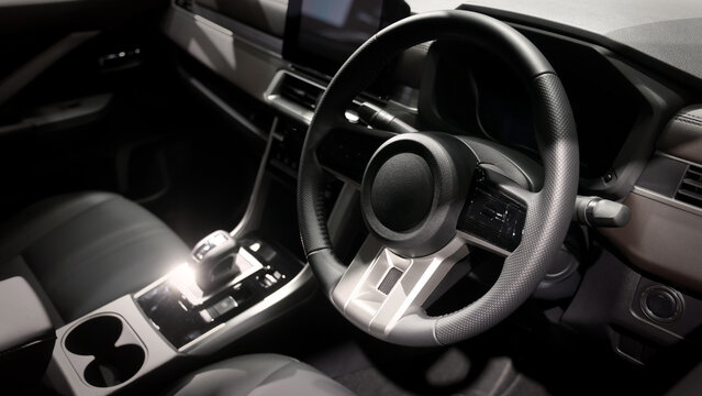 EV Car steering wheel. Modern car interior with luxury steering wheel dashboard and digital monitor controls. Steering wheel and automotive cabin. Car technology comfort and premium design in EV car.