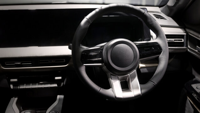 EV Car steering wheel. Modern car interior with luxury steering wheel dashboard and digital monitor controls. Steering wheel and automotive cabin. Car technology comfort and premium design in EV car.