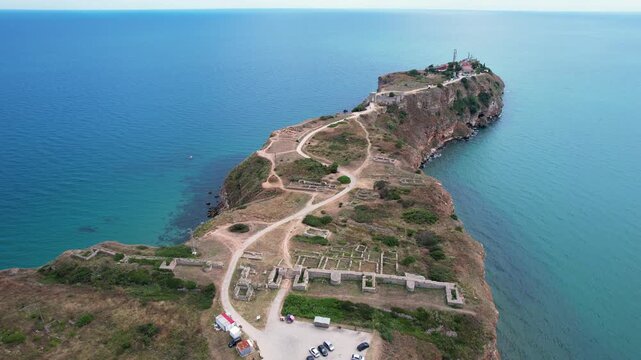 Aerial view of the historic fortress ruins and steep cliffs of Cape Kaliakra surrounded by the Black Sea in Dobrich Province, Bulgaria.