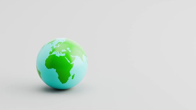 World Planet Rolling Slowly from Left and Stopping on Clean Gray Background with Copy Space. America, Europe, Africa, Asia and Oceania Sides.