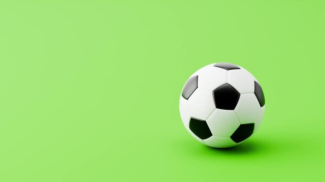 Soccer Ball Rolling Slowly from Left and from Right and Stopping on Clean Green Background with Copy Space