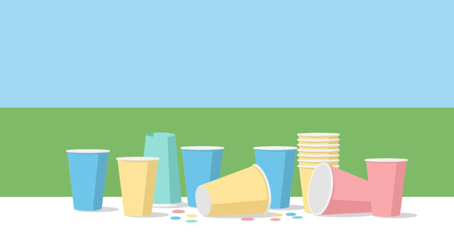 Party Aftermath: Scattered Paper Cups and Confetti on Green Grass