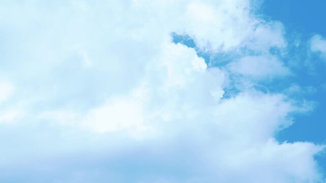 A transition from a completely cloudy sky to a partly cloudy sky and finally to a completely blue sky