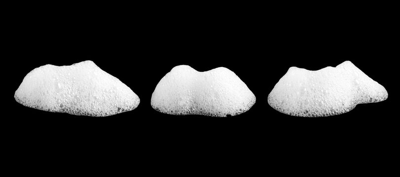 White soap foam bubbles isolated on black background, collection of frothy detergent suds with detailed texture, cleaning and hygiene concept, macro closeup for sanitation and household product design