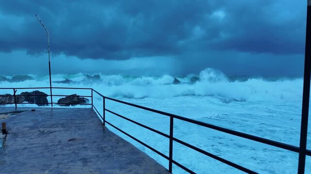 Giant Incoming Wave Viewed from Wet Pier with Diagonal Railing Leading Line and Bent Lamp Post &ndash; Storm Surge
