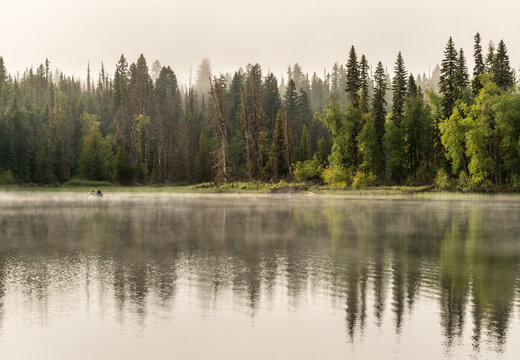 Canada, BC, Bowron Lake Provincial Park.  A canoe on Rum Lake early in morning mist