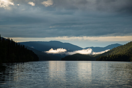Canada, BC, Bowron Lake Provincial Park.   Clouds and mist in the surrounding hills at Isaac Lake.  Bowron Lakes, on the western slopes of the Cariboo Mountains is a popular canoe circuit.