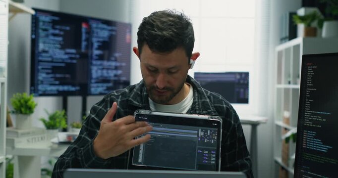 Man coding and presenting in a meeting, demonstrating secure application logic, binary analysis, database flows, cyberspace protections and modern digital interfaces.