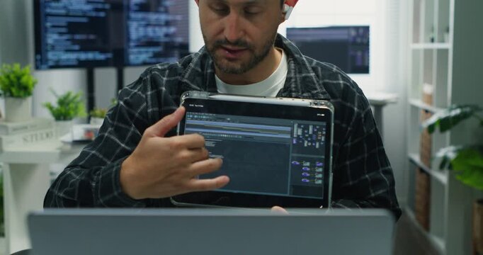 Caucasian man freelancing, coding at desk with tablet and drink, presenting app UI, cloud connection, database sync, network security and AI-enabled software solutions.