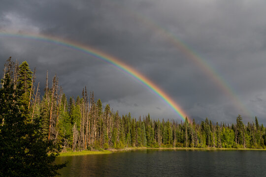 Canada, BC, Bowron Lake Provincial Park. Rainbow over Rum Lake.  Bowron Lakes is a large wilderness area on the western slopes of the Cariboo Mountain Range and a famous canoe circuit.