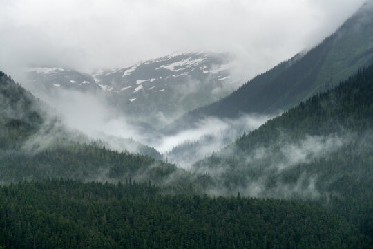 Canada, BC, Bowron Lake Provincial Park. Misty mountain valley at the end of Lanezi Lake.  Bowron Lakes is a wilderness area on the western slopes of the Cariboo Mountains and a famous canoe circuit.