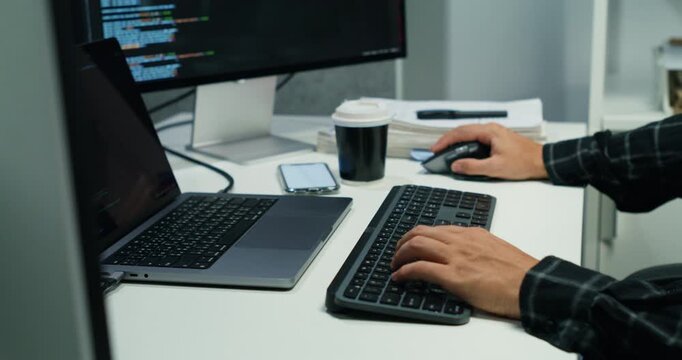 Closeup of a man's hand typing code on a laptop, debugging binary and app interfaces, network and database checks, cybersecurity focus and digital workspace development.