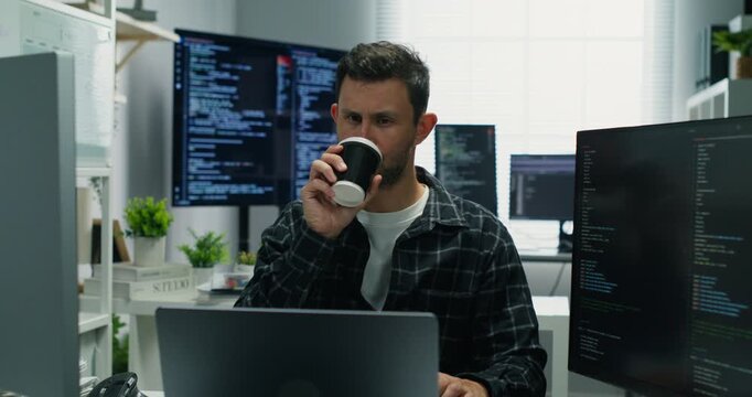  Freelance software developer programs drinkign c coffee while typing secure systems, audits databases, monitors logs, optimizes performance and protects cyberspace.