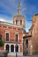 Fototapeta premium Micalet bell tower of Valencia Cathedral from backstreet in Spain. Vertical view, clear blue sky, bright daylight