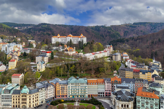 Karlovy Vary view with Hotel Central and Imperial Sanatorium, Czech Republic. High angle, spring blossom, clouds, daylight