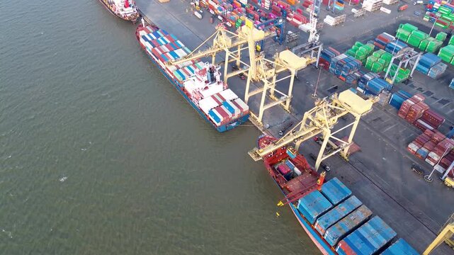 Cargo ships and crane operations at industrial container terminal aerial