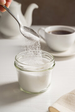 Pouring spoon of sweetener in a jar. Sugar alternative, food and nutrition