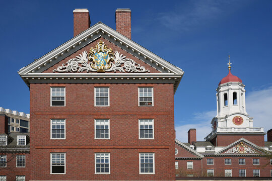 Harvard University building with gilded coat of arms decoration on gable